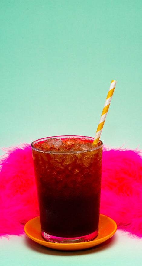 Photo of an iced drink with a straw in it.