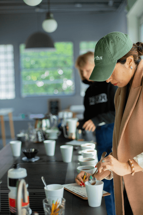 Photo of two people cupping coffee. 