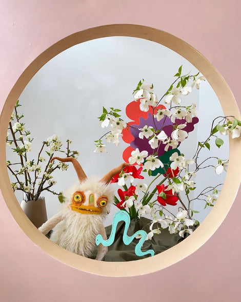 Photo of Wilkins the puppet and flowers.
